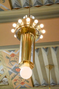 Low angle view of illuminated light bulbs hanging from ceiling