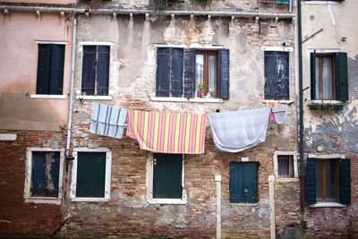 Low angle view of clothes drying outside building