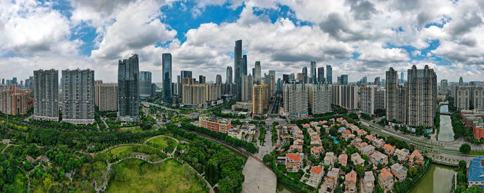 Panoramic view of modern buildings in city against sky