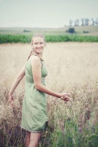 Portrait of a smiling girl standing on field