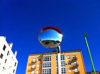 Low angle view of buildings against clear blue sky