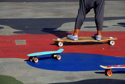 Low section of child skateboarding at park