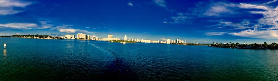 Panoramic view of sea and buildings against sky