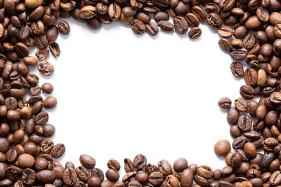 High angle view of coffee beans against white background