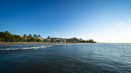 Scenic view of sea against clear blue sky