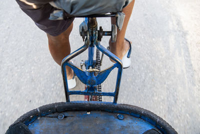 Low section of man riding bicycle on street