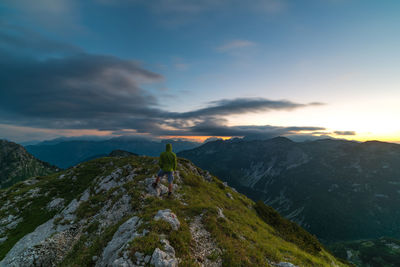 Scenic view of mountains against cloudy sky