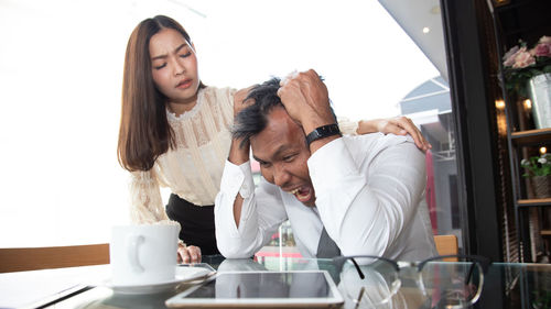 Young woman with coffee cup on table