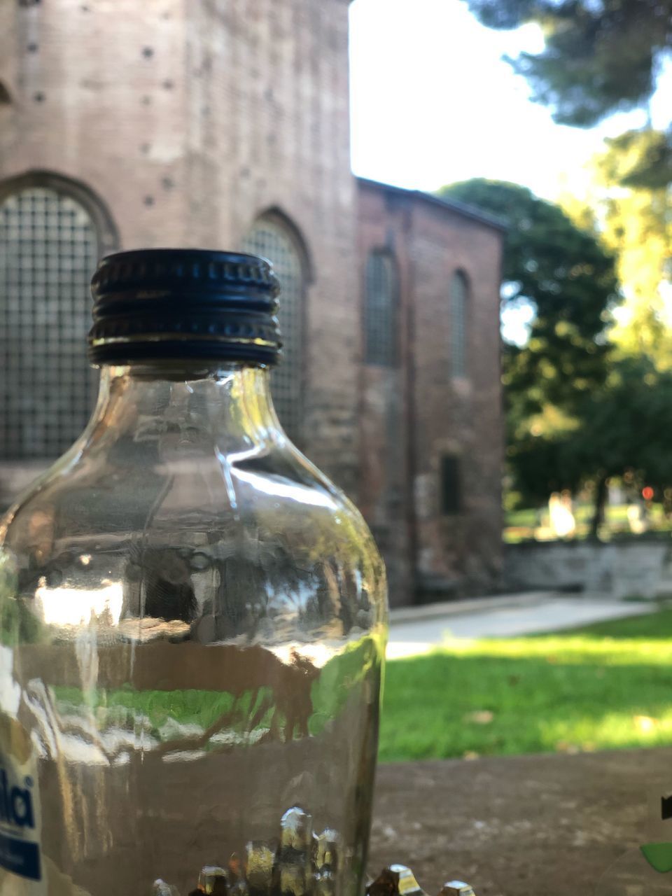 CLOSE-UP OF GLASS WITH BOTTLE