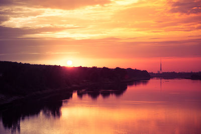 Scenic view of lake against romantic sky at sunset