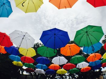 Low angle view of umbrellas against sky