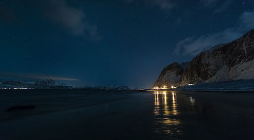 Scenic view of lake against sky at night