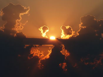 Low angle view of sun in sky during sunset