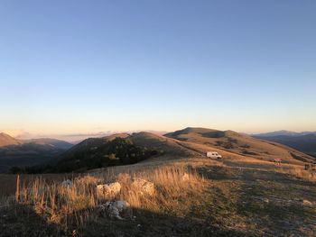 Scenic view of landscape against clear sky during sunset
