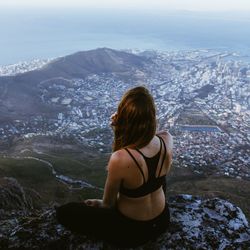 Rear view of woman looking at cityscape