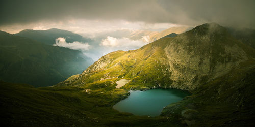 Scenic view of lake against cloudy sky