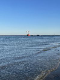 Scenic view of sea against clear blue sky