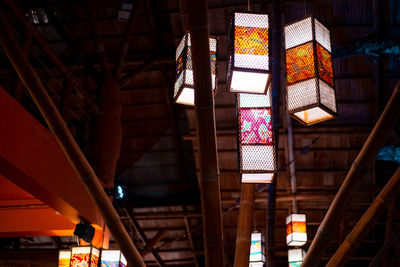 Low angle view of illuminated lanterns hanging in building