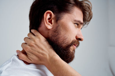 Portrait of young man against white background