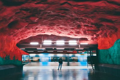 Rear view of people walking in subway