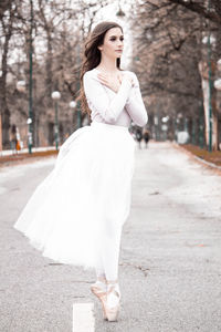 Ballerina dancing on road