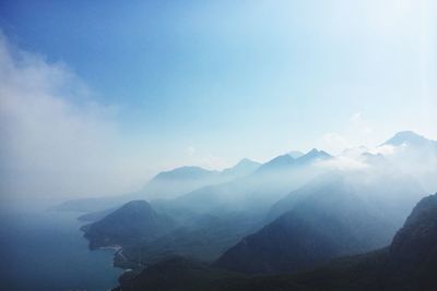 Scenic view of mountains against blue sky