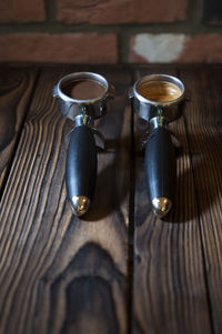 Photo of coffee, pre and post grinded on wooden table