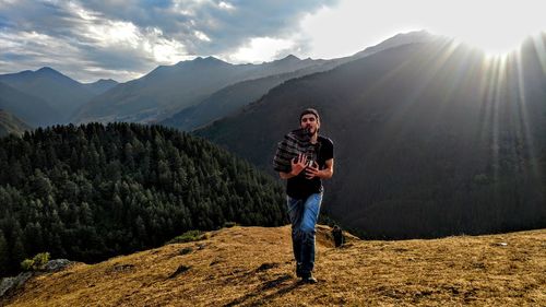 Full length of man on mountain road against sky