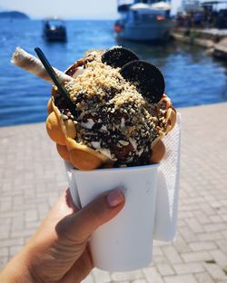 Close-up of hand holding ice cream cone