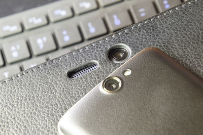 Close-up of mobile phone on keyboard
