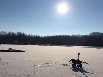 Scenic view of frozen lake against sky during winter