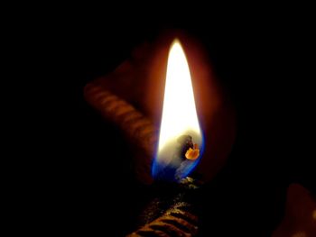 Close-up of illuminated lamp against black background