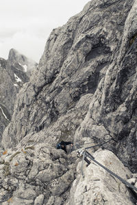 Man hiking on ellmauer halt at kaiser mountains