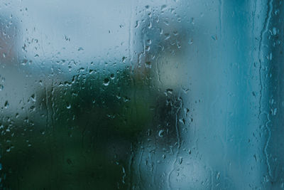 Full frame shot of wet glass window in rainy season