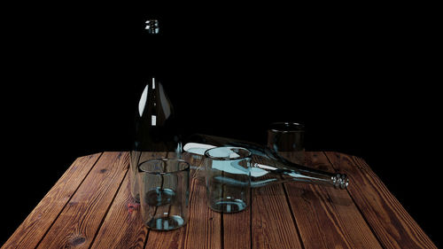 High angle view of glasses on table against black background