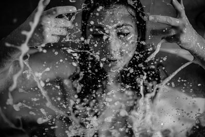 Woman splashing water on face