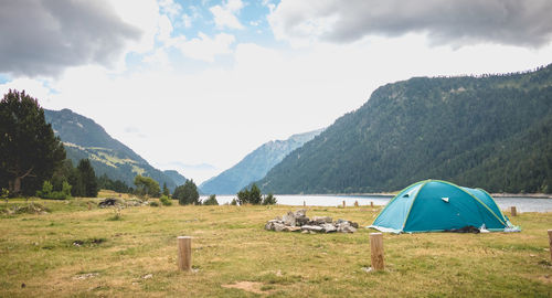 Tent on field against mountains