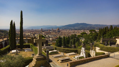 Panoramic view of trees and buildings against sky