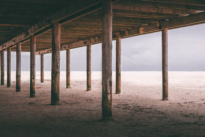 View of pier on sand at beach 