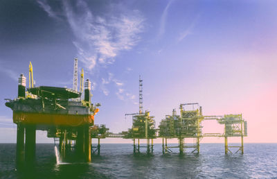 A maintenance rig alongside an oil platform complex. 