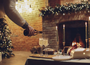 Midsection of woman holding wineglass