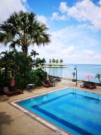 View of swimming pool against cloudy sky