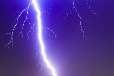 Low angle view of lightning against sky at night