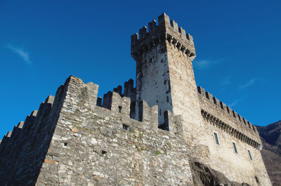 Low angle view of castle against blue sky