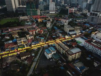 High angle view of illuminated street amidst buildings in city