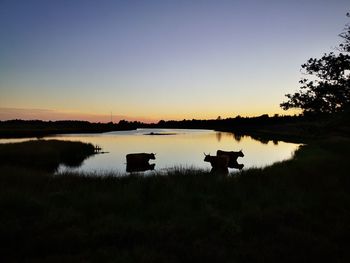 Scenic view of lake against sky during sunset