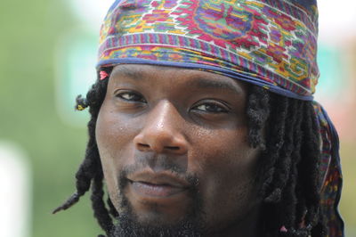 Close up of african american male with dreads wearing head wrap