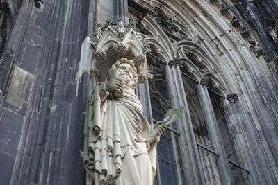 Low angle view of statue against temple