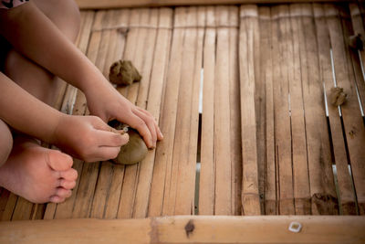 Midsection of person playing with wood