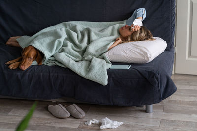 High angle view of woman sleeping on bed